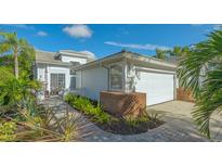Charming single Gathering home featuring manicured landscaping and an attached two-car garage at 7742 Whitebridge Gln, University Park, FL 34201