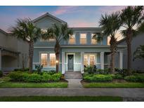 Charming two-story home boasting a landscaped front yard and inviting entrance, framed by swaying palm trees at 12130 Seabrook Ave, Bradenton, FL 34211