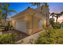 Charming home features a well-manicured front yard and attached two-car garage at 1311 Triano Cir # 1311, Venice, FL 34292