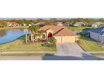 Beautiful single-story home with a well-manicured lawn, a colorful front garden and a two car garage at 2281 Vintage St, Sarasota, FL 34240