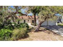 Charming single-story home featuring a well-maintained lawn and mature trees at 3428 Mineola Dr, Sarasota, FL 34239