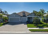 Charming single-Gathering home with a manicured lawn and a spacious two-car garage at 5621 Badini Way, Palmetto, FL 34221