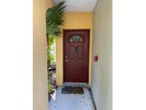 Charming front door with a secure lock, inviting entrance to the property at 5681 Bentgrass Dr # 13-201, Sarasota, FL 34235