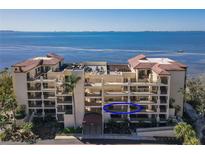 Beautiful condo building with balconies overlooking scenic water views and lush landscaping at 6460 Mourning Dove Dr # 204, Bradenton, FL 34210