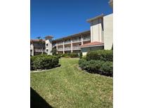 Attractive condo building featuring multiple stories and exterior balconies on well-manicured grounds at 6505 Stone River Rd # 306, Bradenton, FL 34203