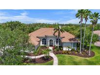 Charming single-story home with manicured lawn, mature palms and barrel tile roof at 6637 Taeda Dr, Sarasota, FL 34241
