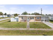 Charming single-story home with well-maintained front lawn and mature landscaping at 8798 Herbison Ave, North Port, FL 34287