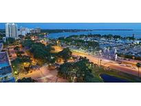 Beautiful aerial view showcasing the city and bay with lush landscaping and a bustling marina at 101 S Gulfstream Ave. # 9C, Sarasota, FL 34236