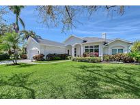 Beautiful single-Gathering home with manicured front yard, garden, and attached two-car garage at 1110 93Rd Nw St, Bradenton, FL 34209