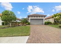 Charming single-Gathering home boasts a paved driveway and lush landscaping at 12659 Sorrento Way, Bradenton, FL 34211