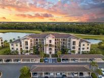 Beautiful aerial view of condo complex with sunset, golf course and pond view at 17510 Gawthrop Dr # 305, Bradenton, FL 34211