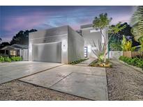 Modern home exterior with concrete driveway, a two-car garage and manicured landscaping at 2327 Hillview St, Sarasota, FL 34239