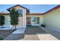 Charming front entrance with decorative glass door, mature tree, and well-maintained walkway at 3704 Prairie Dunes Dr, Sarasota, FL 34238
