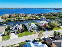 Waterfront home boasts lush landscaping, a private dock, and stunning views of the tranquil canal and bay at 3707 5Th Ne Ave, Bradenton, FL 34208