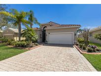 Attractive single-story home featuring well-manicured lawn, brick border, and paver driveway to a 2-car garage at 4134 63Rd E Ter, Sarasota, FL 34243