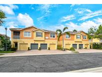 Well-maintained townhouses featuring colorful exteriors, garages, and manicured landscaping at 7979 Limestone Ln # 14-101, Sarasota, FL 34233