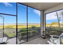 Screened-in porch featuring beautiful views, brick pavers, outdoor seating, and a grill at 910 Tidewater Shores Loop # 107, Bradenton, FL 34208