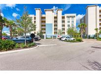 Well-maintained condominium building with palm trees, landscaping, and parking at 10530 Boardwalk Loop # 502, Bradenton, FL 34202