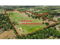 Expansive 26.9-acre parcel featuring a barndominium and multiple ponds surrounded by lush greenery at 28120 63Rd E Ave, Myakka City, FL 34251