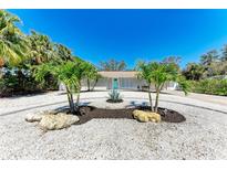 Charming home featuring an artful circular driveway with palm trees and bright, stylish curb appeal at 3304 7Th Street W Ct, Palmetto, FL 34221