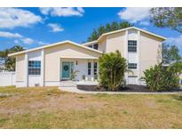 Charming two-story home featuring a welcoming blue front door and beautifully landscaped front yard at 4406 17Th W St, Palmetto, FL 34221