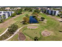 Aerial view of a golf course community with mature trees and a pond at 4440 Ironwood Cir # 509D, Bradenton, FL 34209