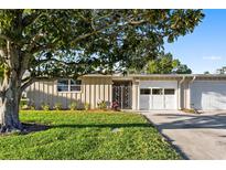 Charming single-story home with a well-manicured lawn and a covered front entrance at 7122 11Th W Ave, Bradenton, FL 34209