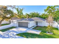 Charming single-story home with a well-manicured front lawn, two car garage, and beautiful landscaping at 1422 19Th St, Sarasota, FL 34234