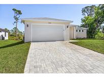 Charming home featuring a spacious two-car garage and a beautifully paved driveway at 2364 Carpenter Ln, North Port, FL 34286