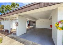 Spacious carport offers covered parking and easy access to the home's entrance and decorated with seasonal decorations at 3908 Panola Ln # 193, Sarasota, FL 34232