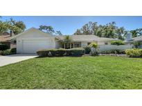 Charming single-story home with a well-manicured lawn and a two-car garage at 4420 Oak View Dr, Sarasota, FL 34232