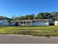 Charming single-story home with a covered carport and well-maintained front lawn at 4431 W Wallace Ave, Tampa, FL 33611
