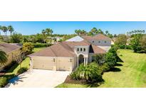 Beautiful two-story home with a three-car garage and manicured front lawn, set amongst swaying palm trees at 4706 Balboa Park Loop, Bradenton, FL 34211