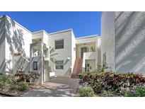 Inviting condo featuring a neatly landscaped entrance and a brick staircase leading to the front door at 5078 Marsh Field Rd # 82, Sarasota, FL 34235