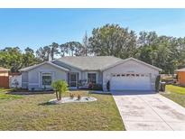 Charming single Gathering home with well-manicured lawn and a two car garage at 5330 Alseir Rd, North Port, FL 34288