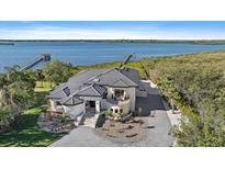Stunning waterfront home with a private dock, lush landscaping, and a beautiful architectural design at 6178 9Th Avenue Ne Cir, Bradenton, FL 34212
