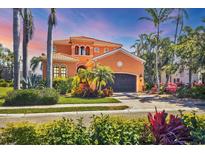 Beautiful two-story house featuring a well-maintained yard, driveway, and a two-car garage at 6211 Legends Blvd, Bradenton, FL 34210