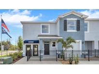Charming two-story townhome with a well-manicured front yard and classic architectural details at 11830 Davis Dr, Largo, FL 33774