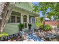 Inviting front porch with tiled walkway and well-maintained landscaping in this charming home at 1679 Arlington St, Sarasota, FL 34239