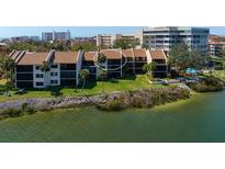Waterfront condos feature lush landscaping, direct water access, and scenic views of the intercoastal waterway at 1900 Cove Ii Pl # 133, Sarasota, FL 34242