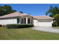 Charming single-story home with a tile roof, well-manicured lawn, and an attached two-car garage at 2097 Wasatch Dr, Sarasota, FL 34235