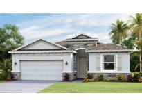 Beautiful single Gathering home with stone accents, neutral color palette, manicured lawn and two-car garage at 5627 Silver Moonlight Dr, Palmetto, FL 34221