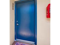 Blue painted front door with silver handle on a cream colored wall at 700 Golden Beach Blvd # 222, Venice, FL 34285