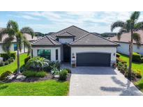 Charming single-story home featuring a beautifully landscaped yard and a gray tile roof at 17604 Hickok Belt Loop, Bradenton, FL 34211