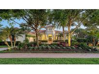 Stunning home featuring a tile roof, tower entry, and mature landscaping at 3153 Founders Club Dr, Sarasota, FL 34240