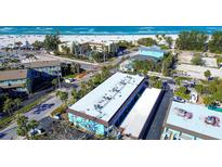 An aerial view shows the property's proximity to the beach and nearby amenities at 4307 Gulf Dr # 202, Holmes Beach, FL 34217