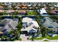 Expansive aerial view of a luxurious home and well-manicured landscaping with canal access in an upscale neighborhood at 541 Fore Dr, Bradenton, FL 34208