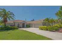 Charming single-Gathering home with a tile roof, well-manicured lawn and mature landscaping, creating great curb appeal at 5518 Eastwind Dr, Sarasota, FL 34233