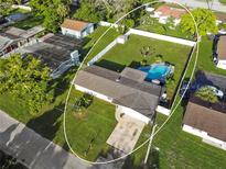 Aerial view of home featuring a spacious backyard with a pool, seating area, and white perimeter fence at 5524 25Th W St, Bradenton, FL 34207