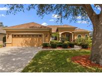 Charming single-story home with well-manicured lawn, complemented by a two-car garage and inviting front entryway at 12211 Aster Ave, Bradenton, FL 34212